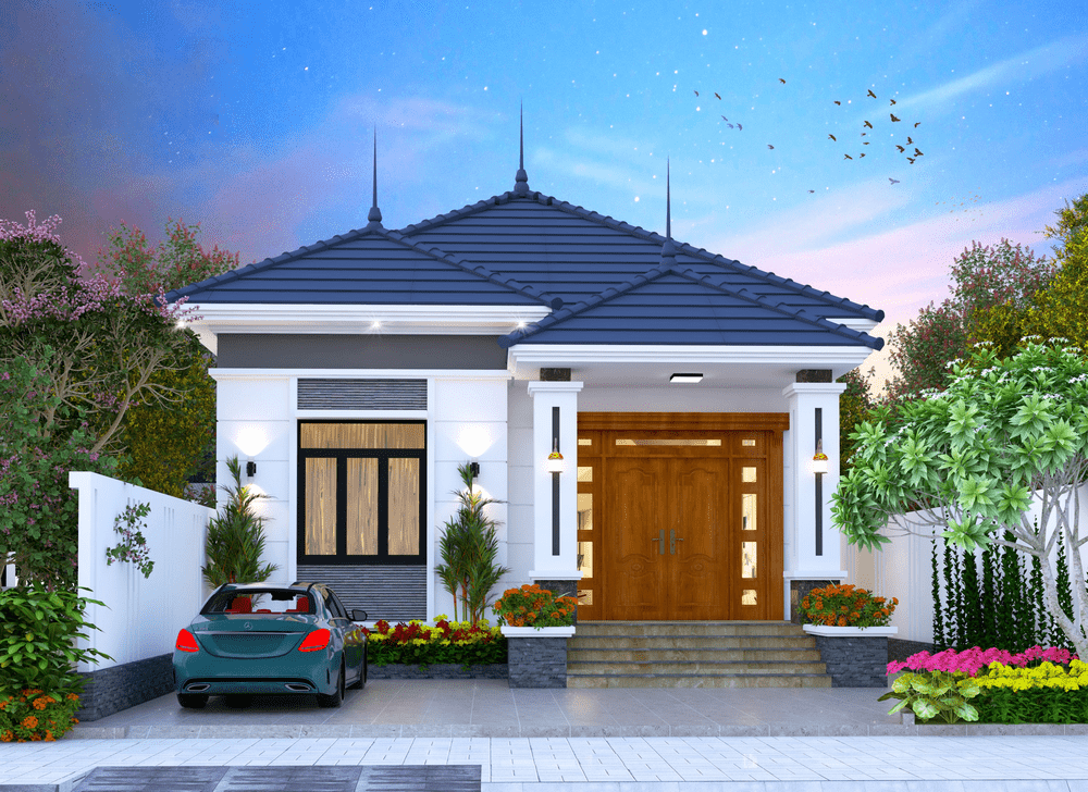 Nhà cấp 4 hiện đại với mái thái, vườn bao quanh và xe hơi xanh đỗ trước, giữa khung cảnh thiên nhiên nhẹ nhàng.