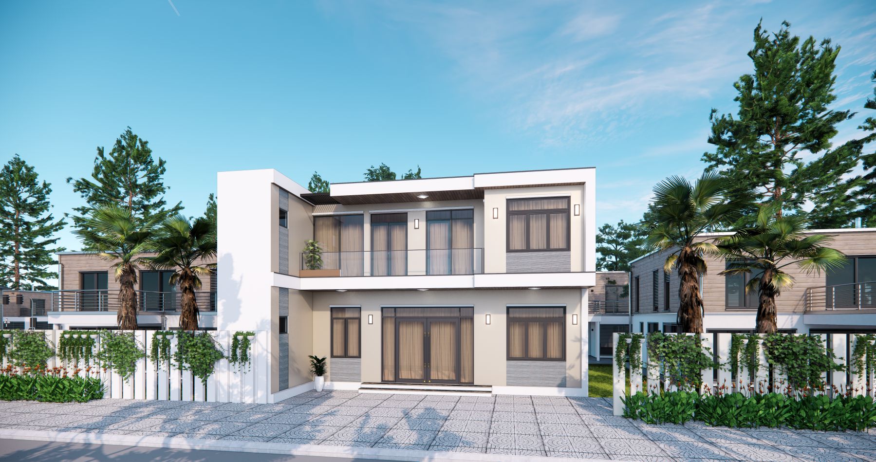 Ngôi nhà hiện đại hai tầng với cửa kính lớn, cây xanh và hàng rào trắng, bầu trời trong xanh.