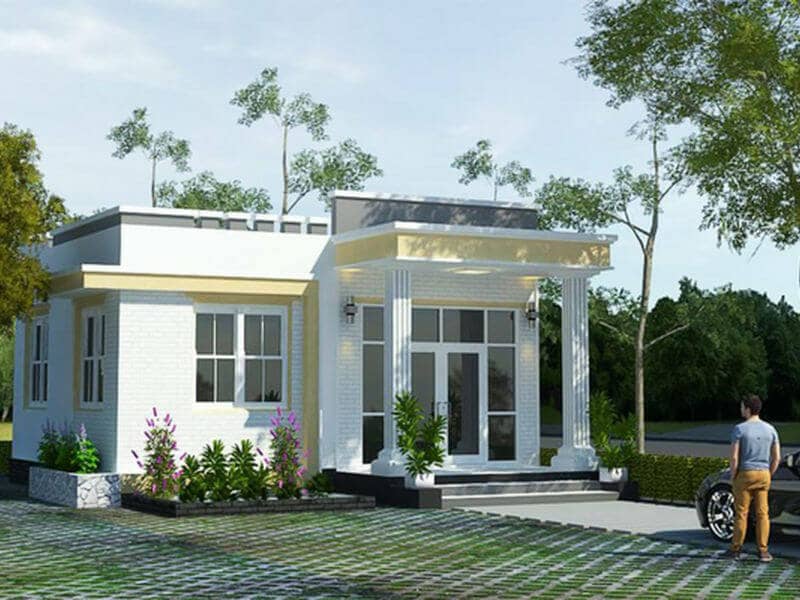 Nhà cấp 4 hiện đại với sân vườn xanh, cửa kính lớn, người đứng cạnh xe máy trước nhà.