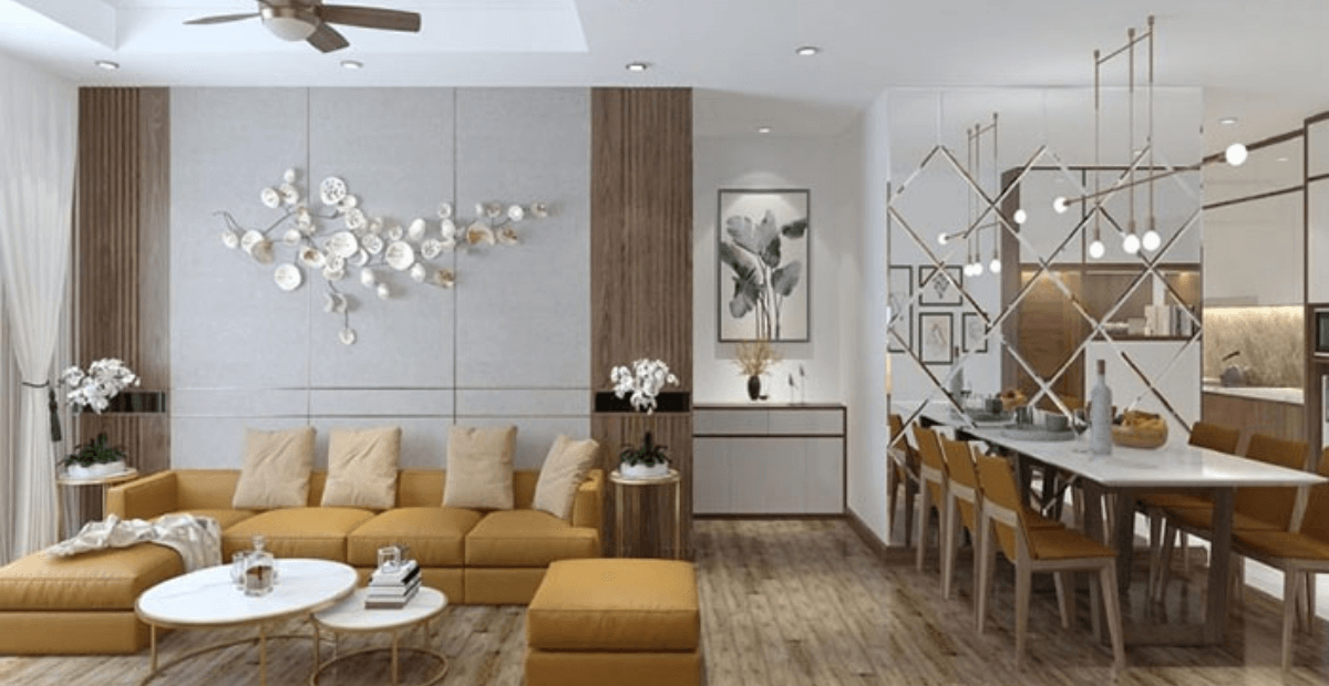 Phòng khách hiện đại với sofa vàng, bàn ăn dài, đèn trần và trang trí tường tinh tế, tạo không gian sang trọng.