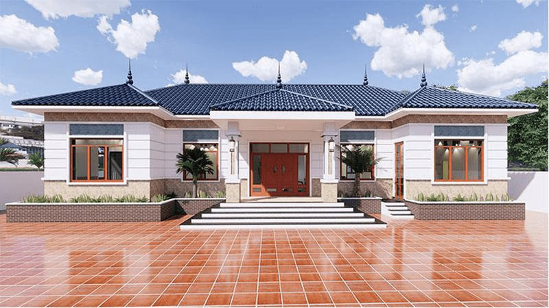 Ngôi nhà lợp mái ngói xanh, sân lát gạch đỏ, thiết kế hiện đại với cửa sổ lớn và cây xanh, bầu trời xanh với mây trắng.