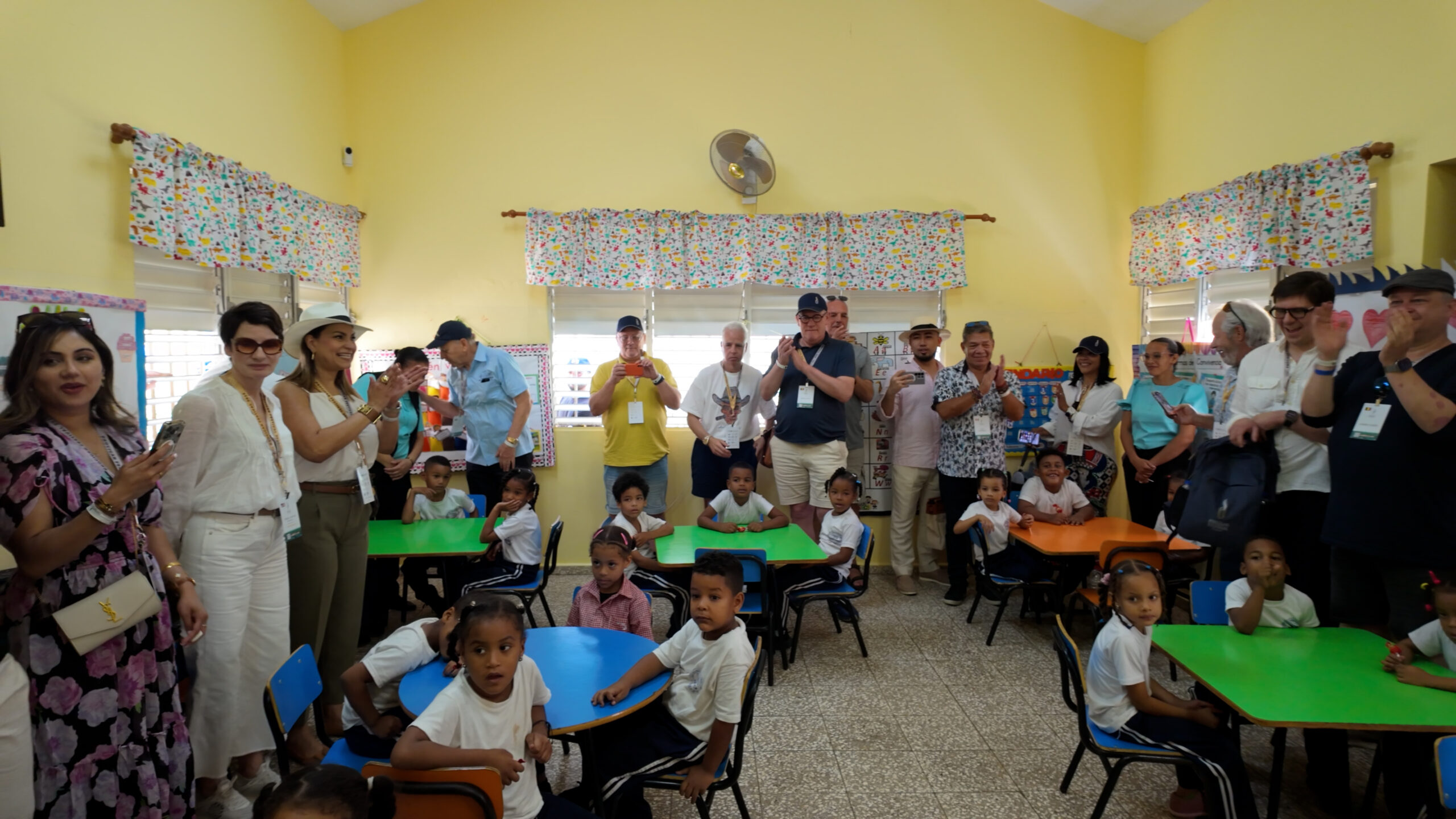 Khách du lịch và trẻ em trong lớp học vui vẻ tại trường tiểu học màu sắc rực rỡ.