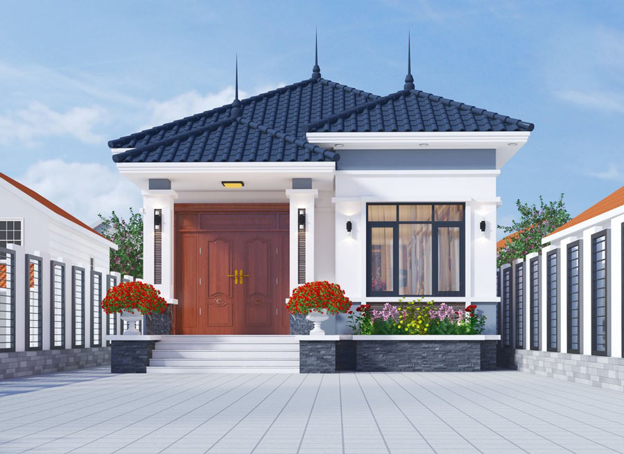 Nhà cấp 4 mái Thái hiện đại với sân rộng, tường và cửa lớn bằng gỗ, cây cảnh sắp xếp trước nhà.