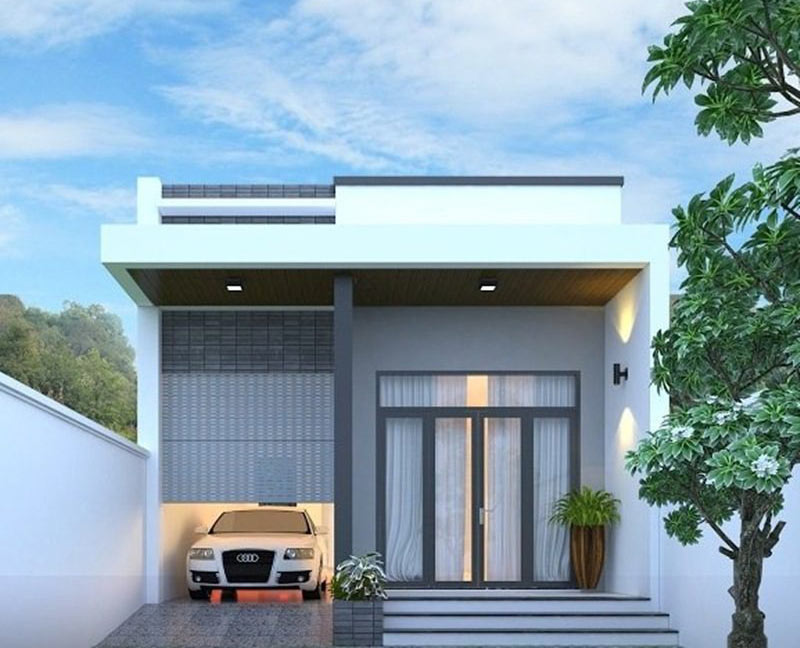 Ngôi nhà cấp 4 màu trắng hiện đại với cửa kính lớn, bên trong gara có ô tô và xung quanh có cây xanh phủ quanh.