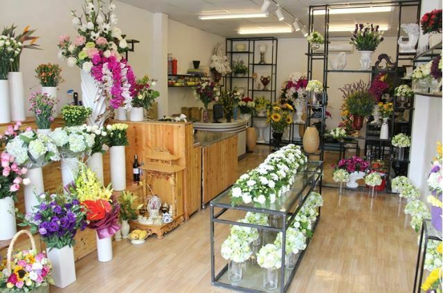 Cửa hàng hoa tươi với các loài hoa được bài trí đẹp mắt, mang lại không gian tươi sáng và rực rỡ.