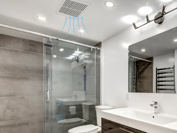 Phòng tắm hiện đại với buồng tắm kính, gương lớn và hệ thống thông gió trần.