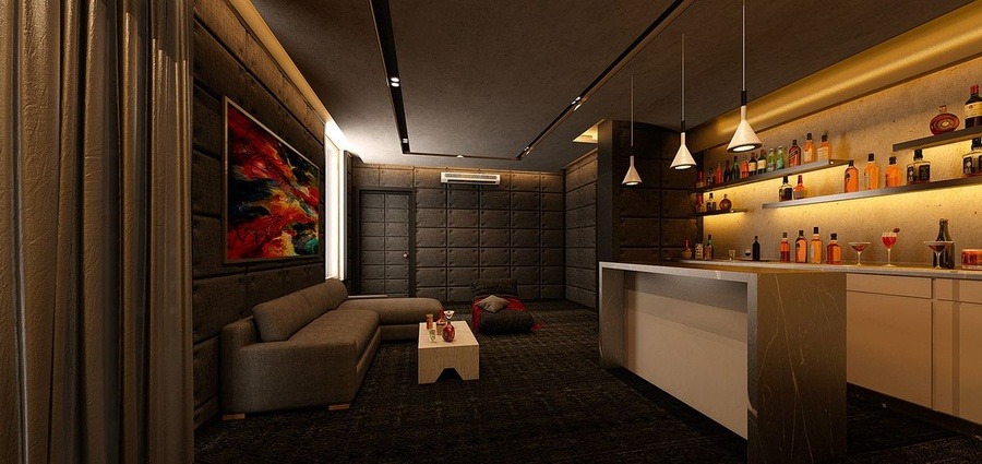 Phòng khách hiện đại với quầy bar, đèn treo, sofa và tranh nghệ thuật tường, ánh sáng ấm áp tạo không gian sang trọng.