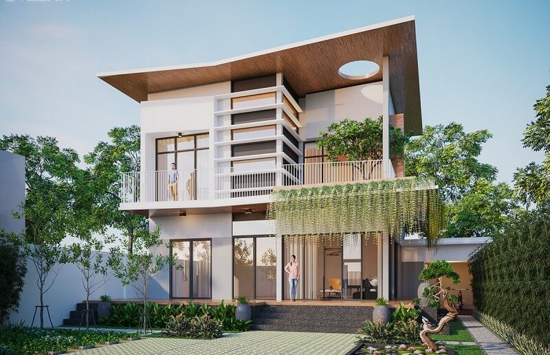 Nhà hiện đại hai tầng với ban công và cây xanh bao quanh, có cửa kính lớn và thiết kế mái độc đáo.