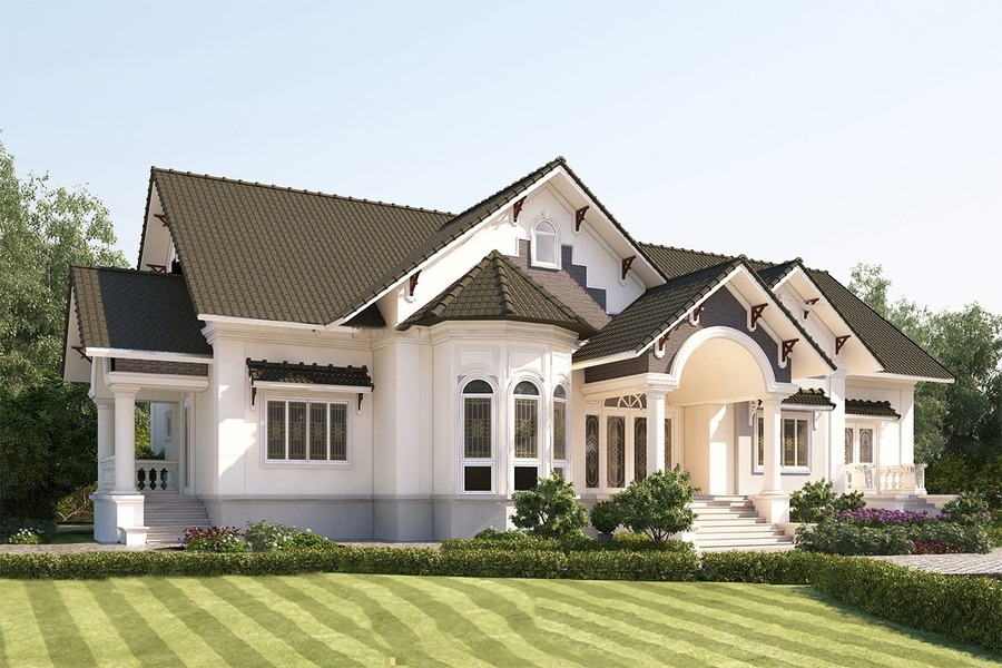 Nhà biệt thự hiện đại với mái ngói đen, tường sơn trắng, sân vườn rộng rãi xanh mát.