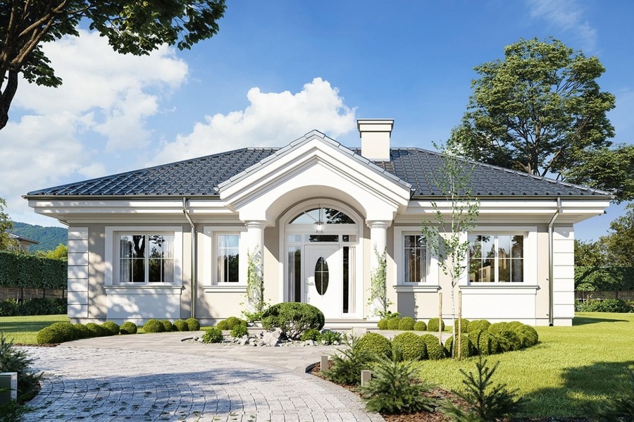 Ngôi nhà một tầng đẹp với mái ngói xanh và khu vườn xanh mát dưới bầu trời trong xanh.