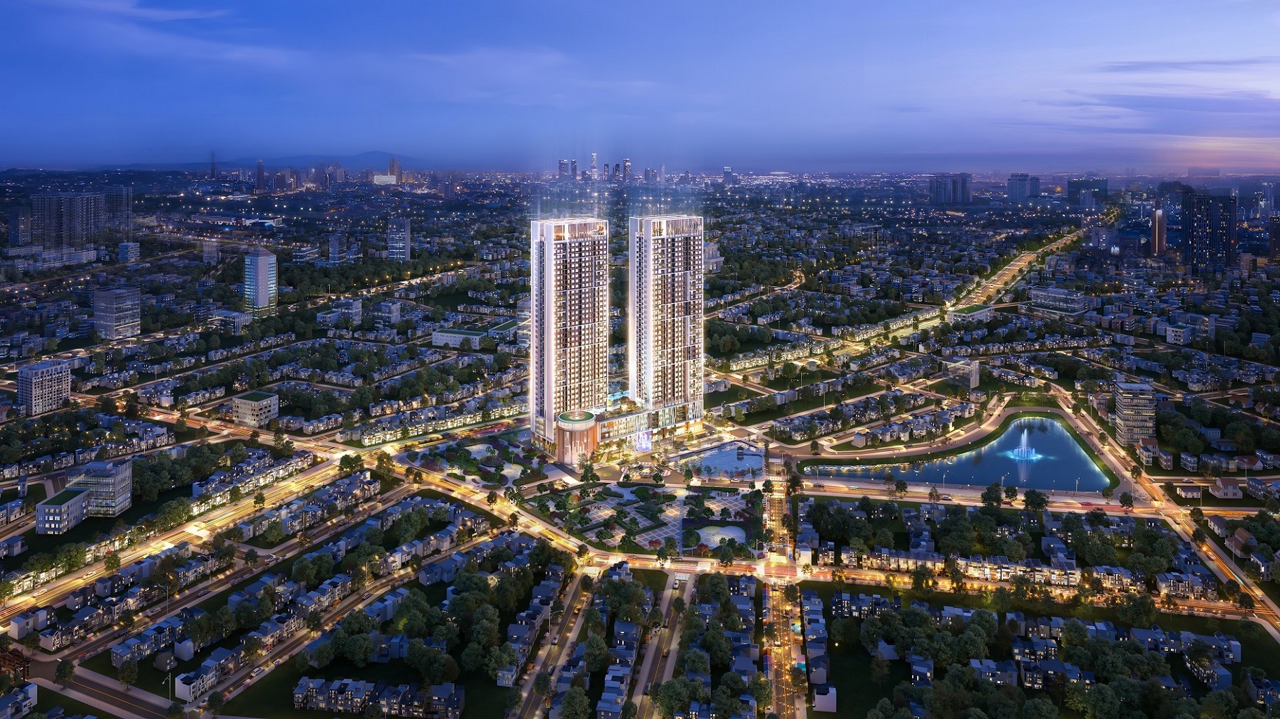 bv-diamond-hill-thai-nguyen Ban đêm tòa nhà cao tầng rực sáng giữa thành phố, hiện đại và sầm uất, bên cạnh hồ nước và cây xanh.