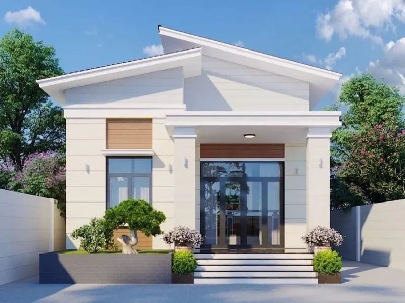 Nhà cấp 4 mái lệch hiện đại, sân vườn nhỏ, cây xanh, bầu trời trong xanh.