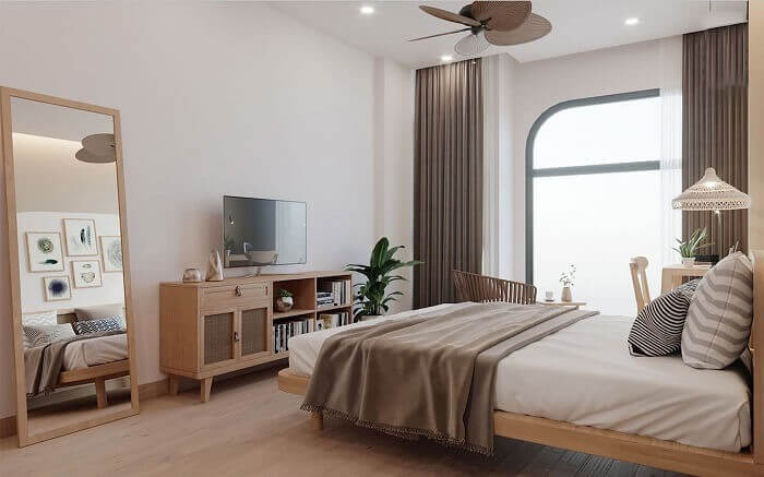 Phòng ngủ hiện đại với nội thất gỗ, cửa sổ lớn và trang trí đơn giản, tạo cảm giác thoải mái và ấm cúng.