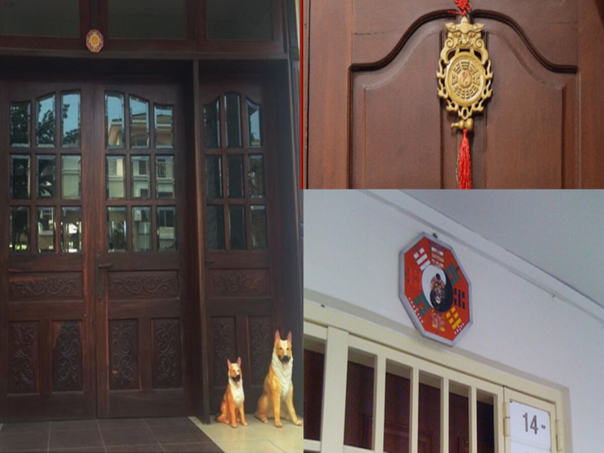 cach-hoa-giai-neu-nha-huong-dong-bac-khong-hop-tuoi-3 Cửa gỗ với tượng chó đá, bùa phong thủy và gương bát quái bảo vệ nhà cửa và mang lại may mắn.