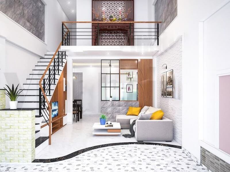 Phòng khách hiện đại với sofa xám, cầu thang gỗ, trang trí tường và bàn trà nhỏ, ánh sáng tự nhiên.