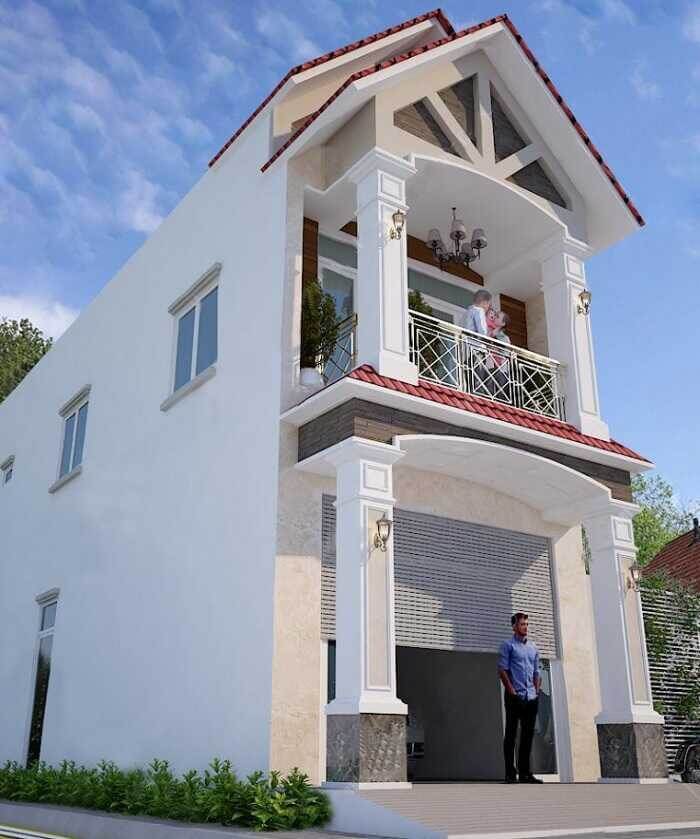 Nhà hai tầng màu trắng với ban công và cửa cuốn, trời xanh, người đứng trước nhà.