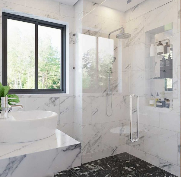 Phòng tắm hiện đại lát đá cẩm thạch với vòi sen, bồn rửa và cửa sổ kính lớn nhìn ra cây xanh.