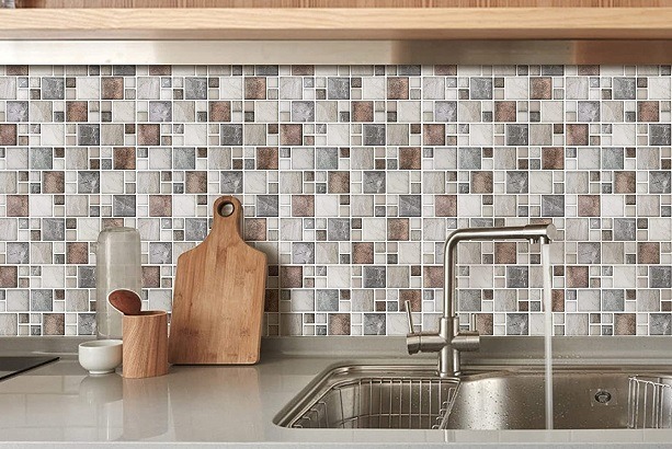 Bếp hiện đại với tường lát gạch vuông trang trí, kệ bếp với chậu rửa và dụng cụ nấu ăn bằng gỗ.