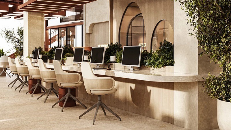 Văn phòng hiện đại với bàn dài, máy tính để bàn, ghế xoay và cây xanh trang trí, không gian mở sáng sủa.