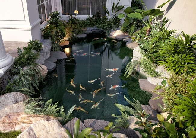 Hồ cá koi trong vườn xanh tươi, bao quanh bởi đá và cây cối, tạo không gian thư giãn tự nhiên.