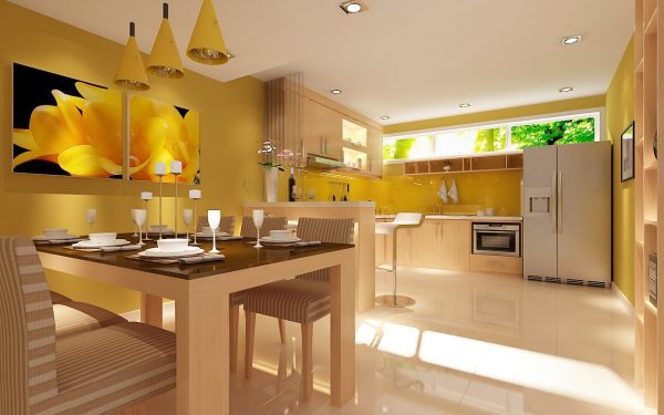 Nhà bếp hiện đại với tông màu vàng ấm, bàn gỗ và đèn treo, tạo không gian sáng và thoải mái.