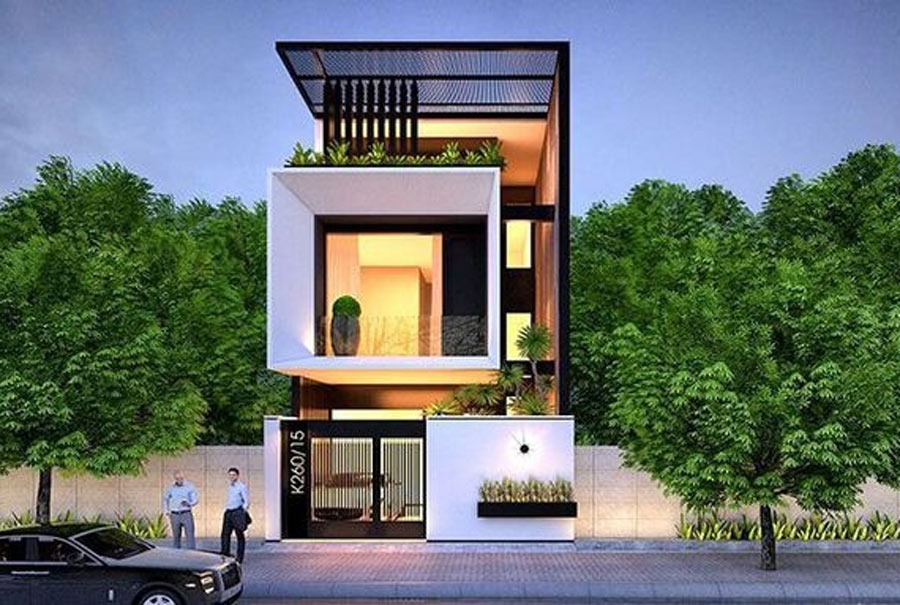 Nhà phố hiện đại 3 tầng với thiết kế góc cạnh, cây xanh bao quanh, hai người đứng trước cửa.