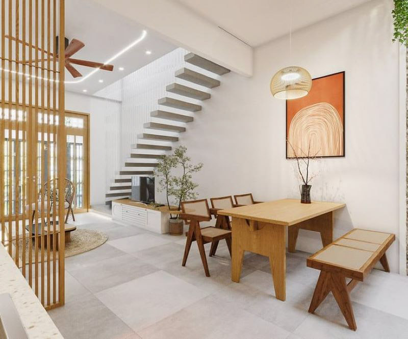 Phòng khách hiện đại với bàn ăn gỗ, cầu thang nghệ thuật và trang trí tối giản.