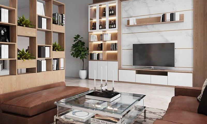 Phòng khách hiện đại với kệ sách, tivi, sofa da và bàn kính trang trí. Trang trí mang phong cách sang trọng, tinh tế.