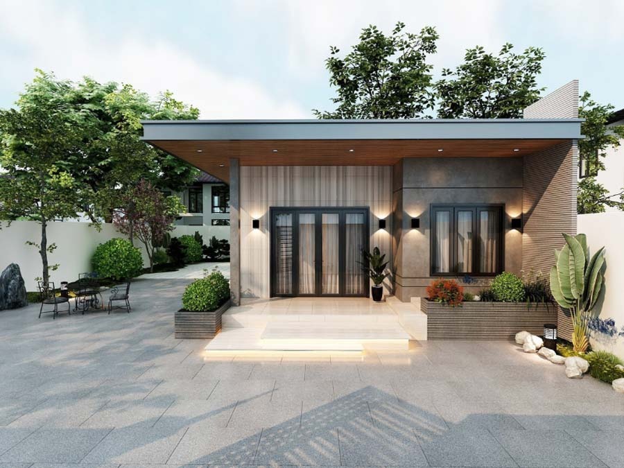 Nhà cấp 4 hiện đại với sân lát gạch, cây xanh trang trí, và ánh sáng đèn LED vào ban ngày.