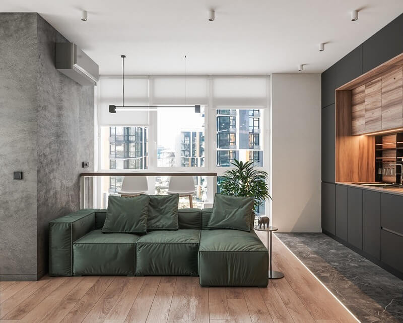 Phòng khách hiện đại với ghế sofa xanh, cửa sổ lớn, nội thất sang trọng và không gian sống tối giản.