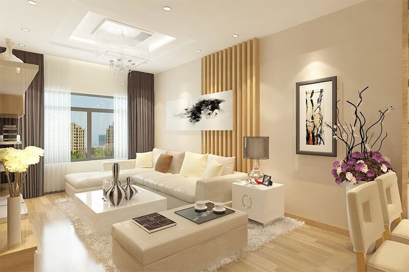 Phòng khách hiện đại với sofa trắng, tranh nghệ thuật, và cửa sổ rộng, ánh sáng tự nhiên tràn ngập.