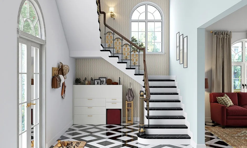 Cầu thang hiện đại trong nhà với nội thất sáng, sàn gạch hoa và cửa sổ lớn ánh sáng tự nhiên.