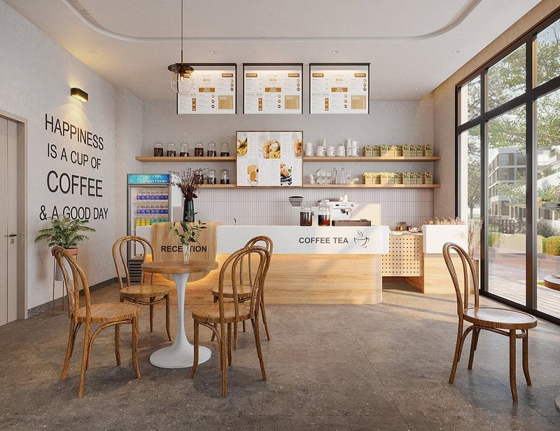 lua-chon-phong-cach-thiet-ke-quan-cafe-thich-hop Quán cà phê thiết kế nội thất ấm cúng với bàn ghế gỗ, bảng thực đơn trên tường và ánh sáng tự nhiên.