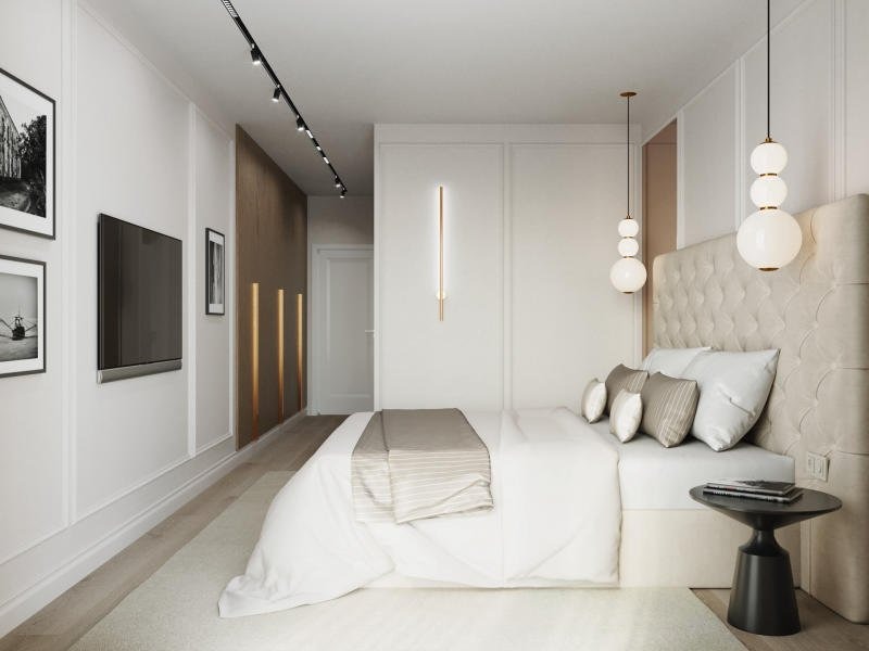Phòng ngủ hiện đại với giường trắng, đèn treo và tranh tường, thiết kế tối giản.