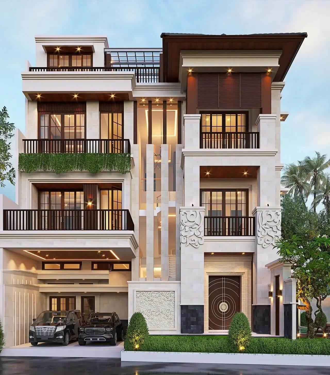 Biệt thự hiện đại màu trắng với ban công và cây xanh, đèn sáng vào buổi tối.