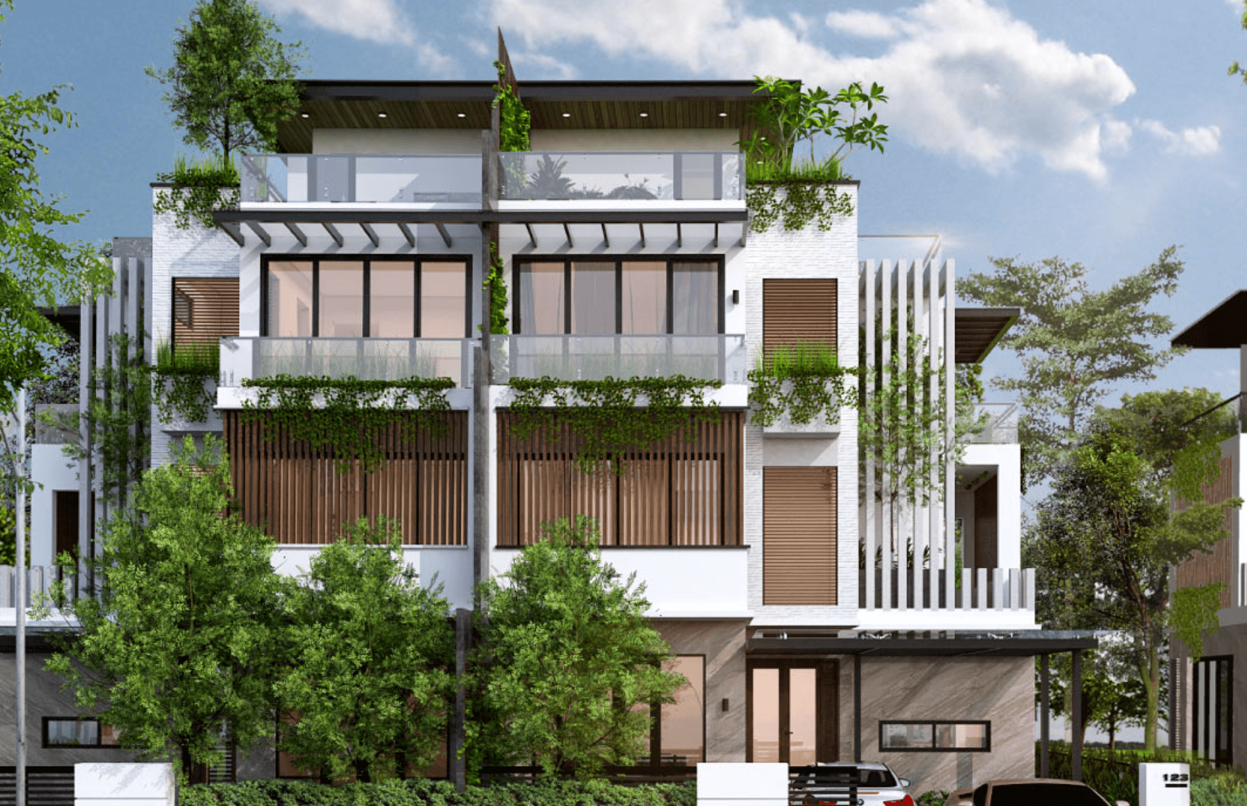 Biệt thự hiện đại với cây xanh trước nhà, thiết kế ba tầng và ban công rộng.