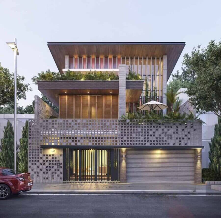 Ngôi nhà hiện đại nhiều tầng với thiết kế sang trọng, cây xanh trên ban công và xe hơi đỏ đậu trước.