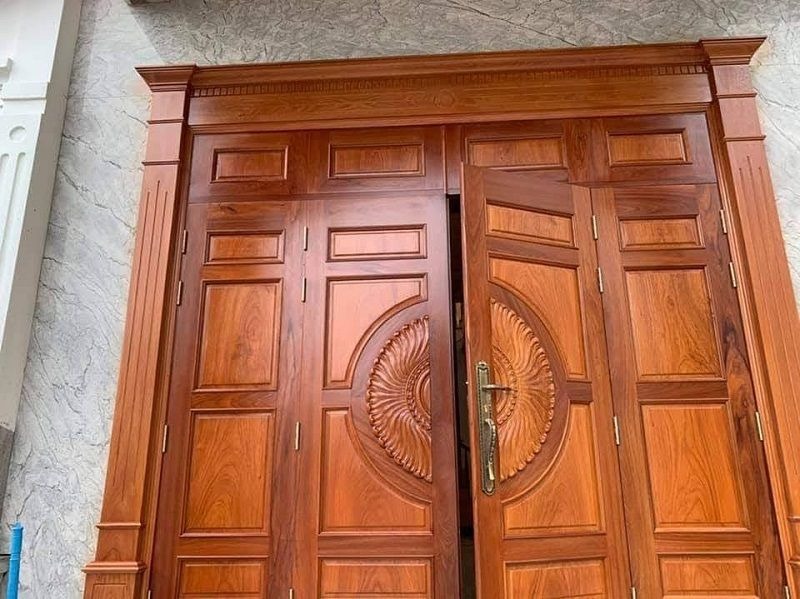 Cửa gỗ nâu sang trọng, họa tiết hoa văn tinh xảo, phù hợp cho biệt thự hoặc nhà phố cao cấp.