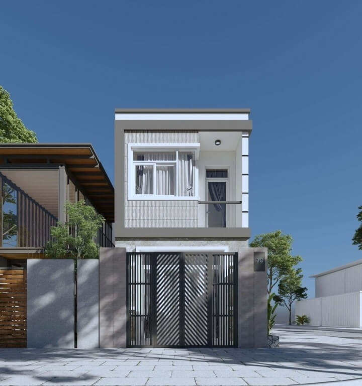 Mặt tiền nhà ống hiện đại với cửa sắt và cửa sổ kính, bầu trời xanh, cây xanh xung quanh.