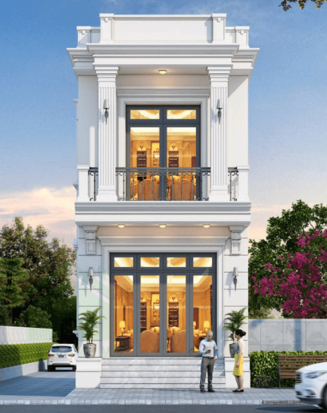 Nhà phố hai tầng phong cách tân cổ điển với cửa kính lớn và cây xanh trang trí, ánh đèn vàng tạo cảm giác ấm áp.