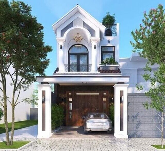 Nhà phố 2 tầng hiện đại với gara ô tô, thiết kế mái vòm và cây xanh xung quanh.