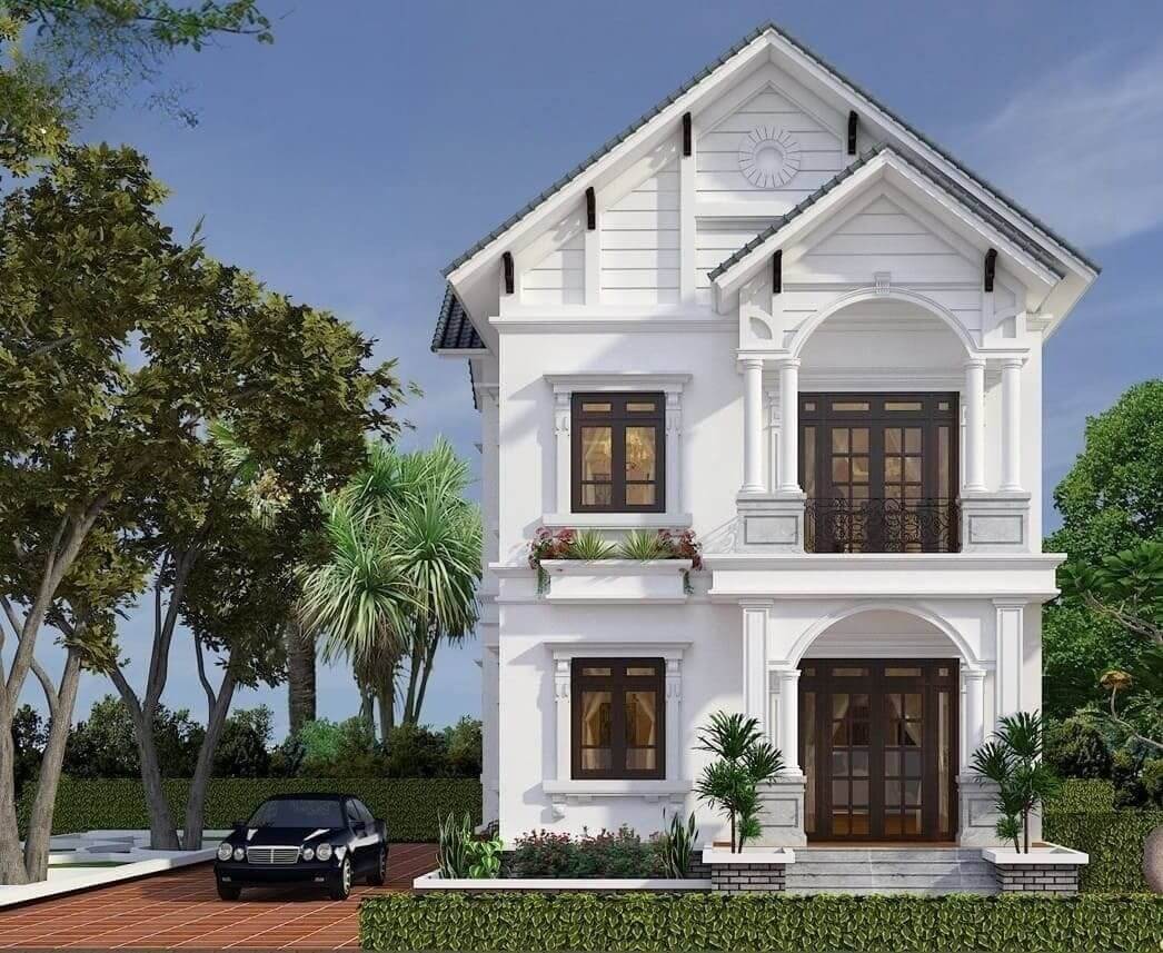 Biệt thự hai tầng trắng phong cách hiện đại với cây xanh xung quanh, có xe đỗ bên ngoài và bầu trời xanh trong.