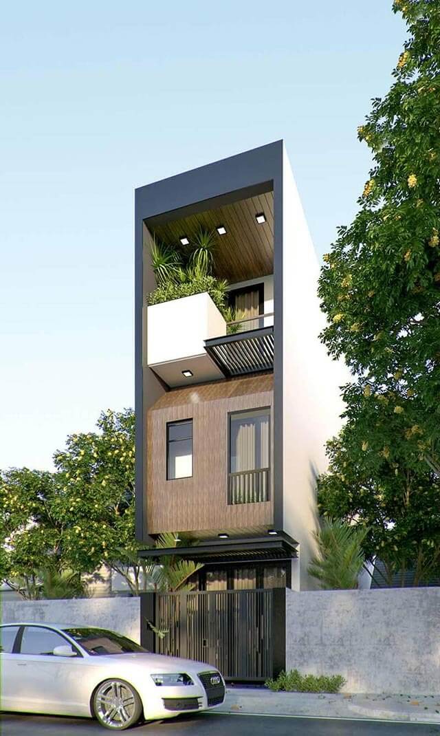 Nhà phố hiện đại ba tầng, ban công xanh, ô tô trắng đỗ phía trước, cây cối xung quanh, trời xanh trong.