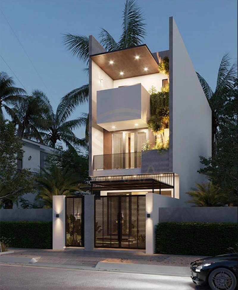 Nhà phố hiện đại hai tầng vào buổi tối, ánh sáng làm nổi bật thiết kế với cây xanh xung quanh.