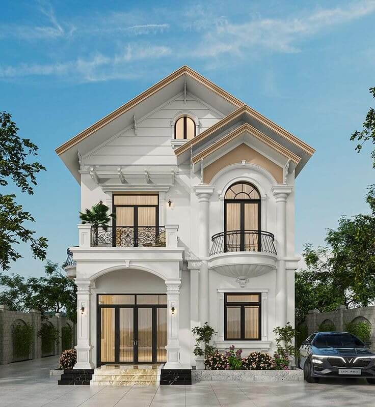 Ngôi nhà 2 tầng kiểu dáng tân cổ điển với cửa sổ kính lớn, ban công và sân rộng có ô tô.