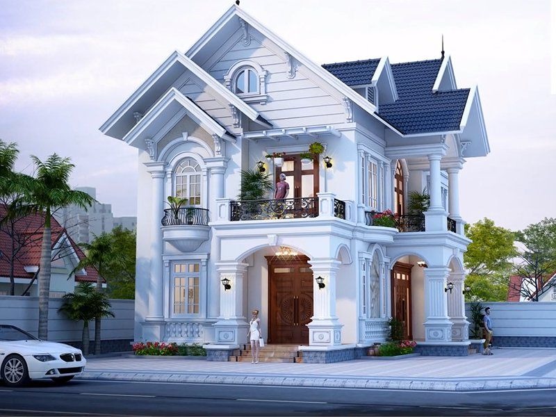 Biệt thự hai tầng sang trọng với mái ngói xanh, thiết kế cổ điển và cây xanh trước nhà.