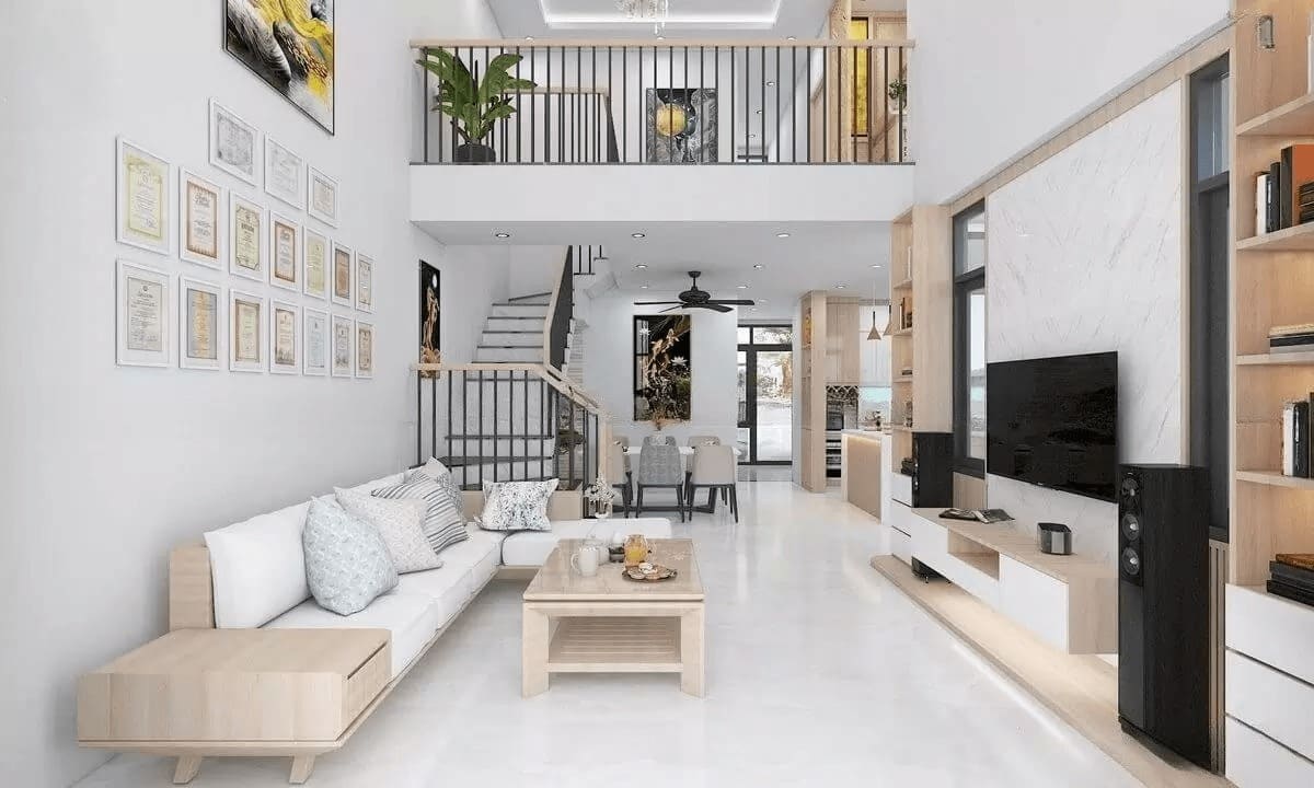 Phòng khách hiện đại với sofa trắng, bàn gỗ, kệ TV lớn, cầu thang và tranh treo tường nghệ thuật.