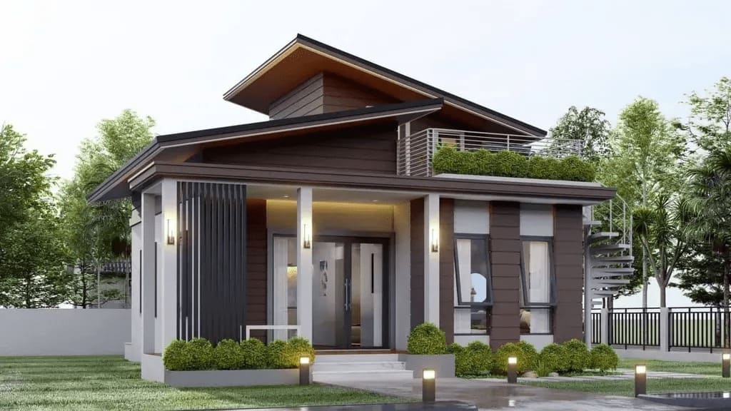 Nhà vườn hiện đại với mái chéo, ban công xanh và cửa kính lớn, bao quanh bởi cây cối xanh tươi.