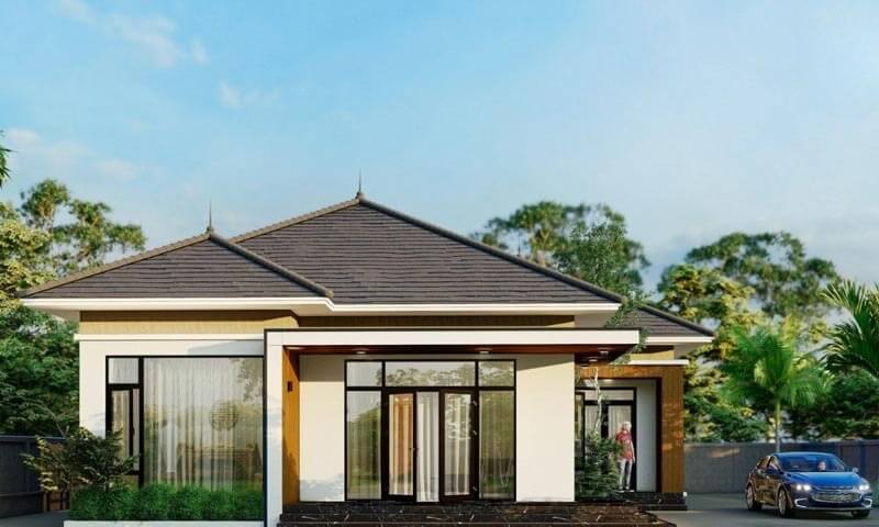 Nhà cấp 4 hiện đại với mái thái đẹp, có ô tô đỗ bên cạnh, bao quanh bởi cây xanh và bầu trời trong xanh.