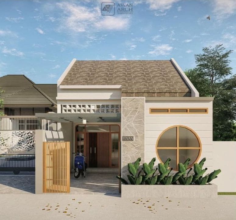 Ngôi nhà hiện đại với mặt tiền gạch ốp, cửa sổ tròn, sân vườn trước xanh mát và mái ngói.